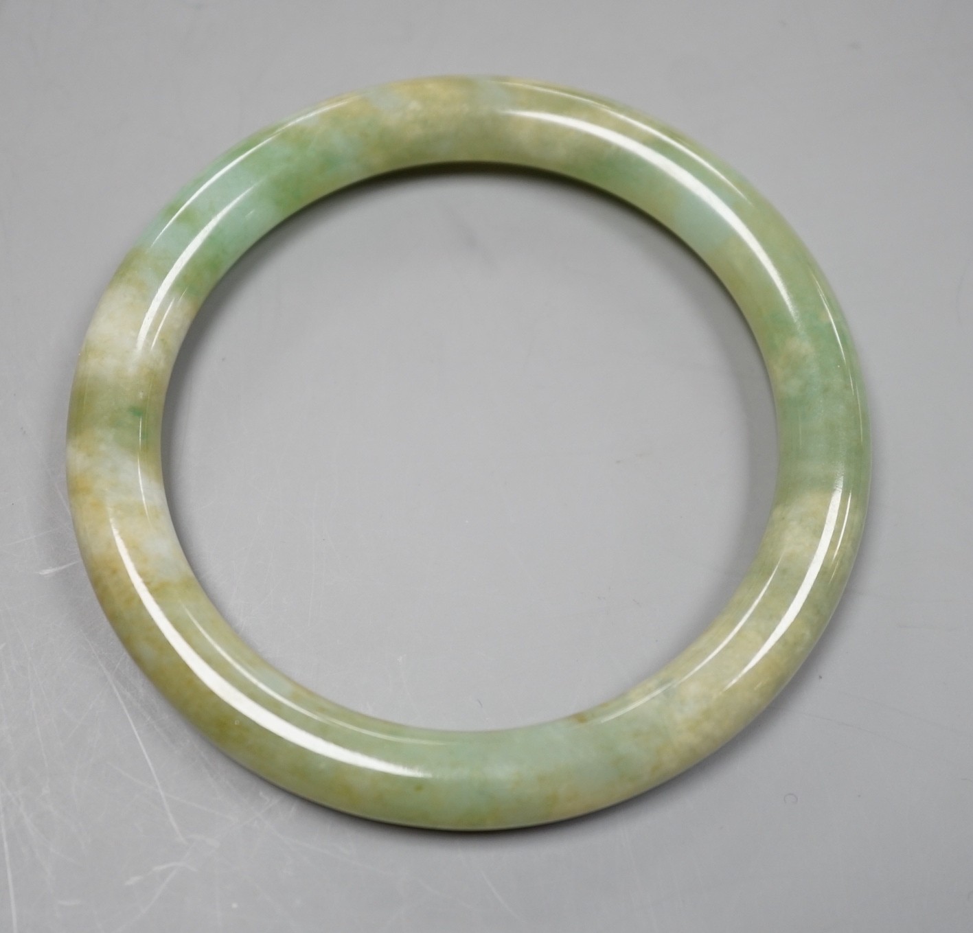 A green hardstone bangle.